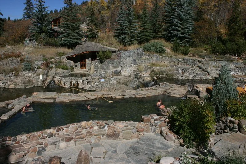 Stone-lined bathing pools and hillside cabins at Strawberry Park Hot Springs (archive photograph)