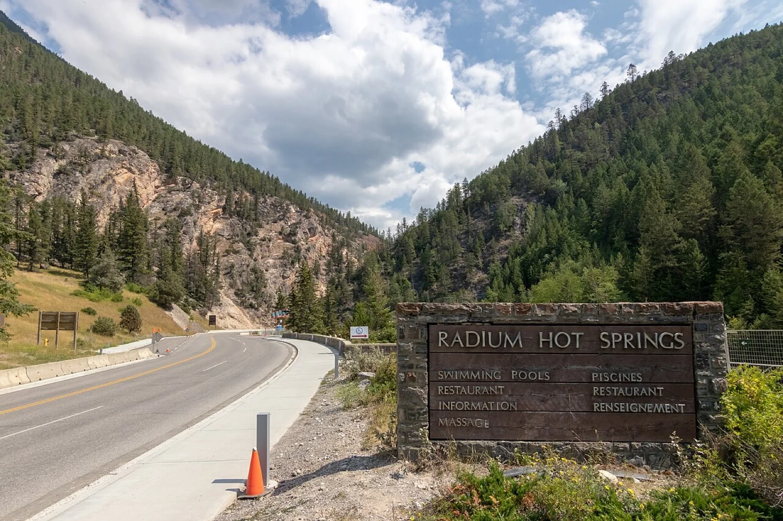 Radium Hot Springs entrance sign and road through Sinclair Canyon in British Columbia