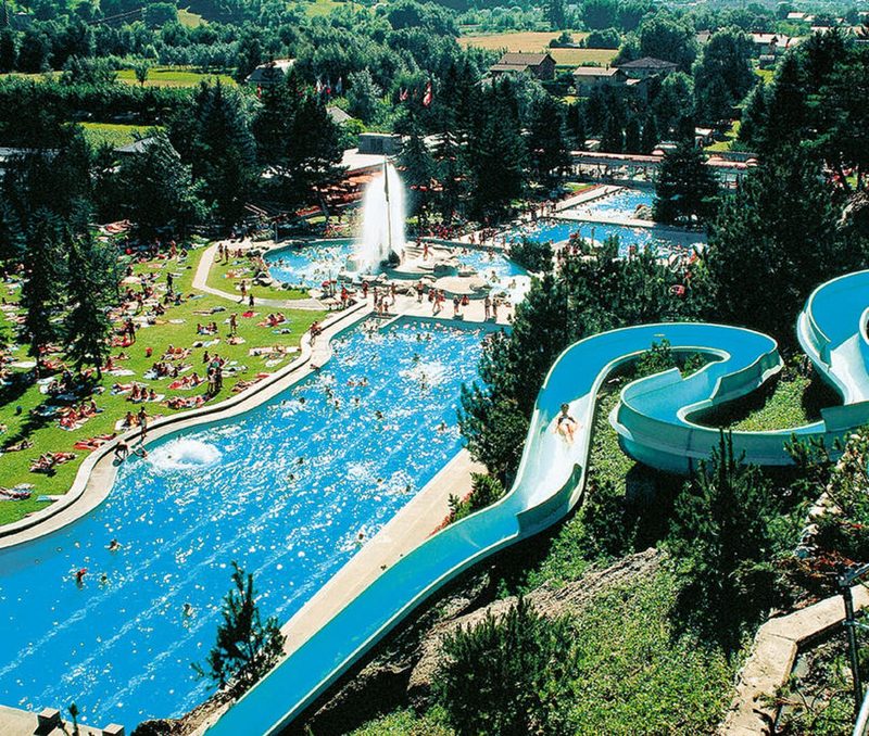 Outdoor thermal pool complex and water slide at Brigerbad Thermal Baths (archive photograph)